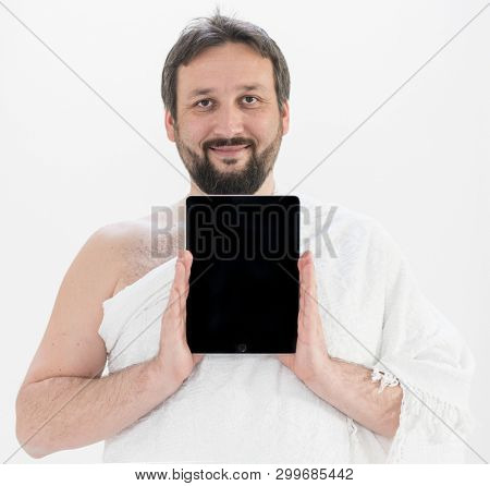 Adult man Hajj holding tablet