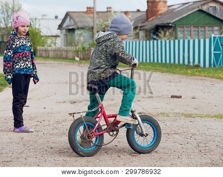 Gomel, Belarus - May 4, 2019: Children Ride A Bike In The Village Of Derbichi.