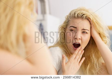Young Blonde Female Feeling Dull And Tired After Waking Up. Woman Yawning Being Sleepy In Bathroom.
