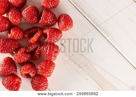 Lot Of Whole Fresh Red Raspberry With Copyspace Flatlay On White Wood