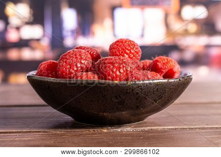 Lot Of Whole Fresh Red Raspberry On Grey Ceramic Plate In A Restaurant