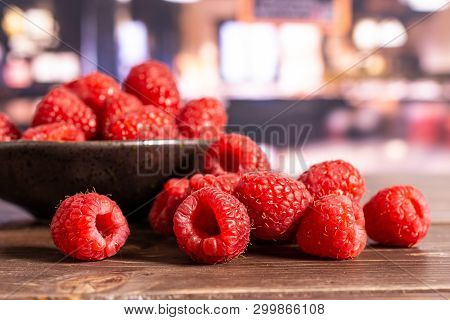 Lot Of Whole Fresh Red Raspberry Stack On Grey Ceramic Plate In A Restaurant