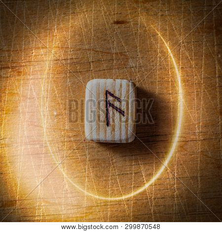 Ansuz. Handmade Scandinavian Wooden Runes On A Wooden Vintage Background In A Circle Of Light. Conce