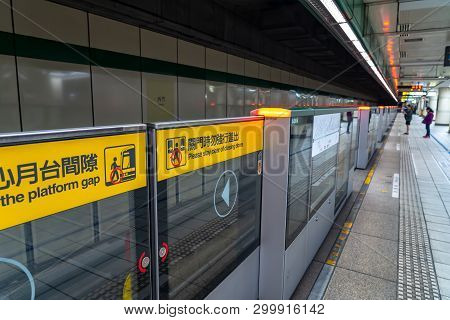 Taipei, Taiwan - April 15, 2019 : Taipei Metro Station Hall And Platform. Subway Passengers Walk Thr
