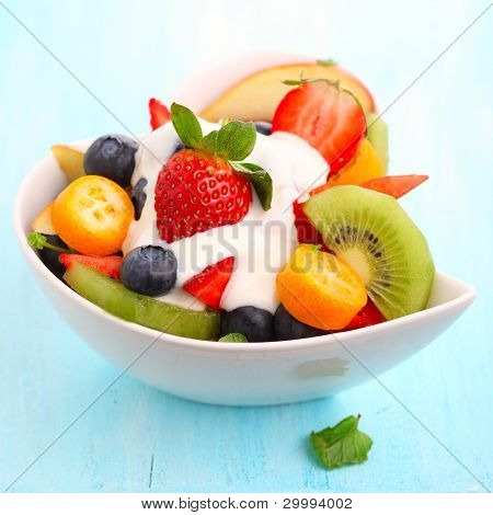 Fruitige zomer salade in witte kom met yoghurt