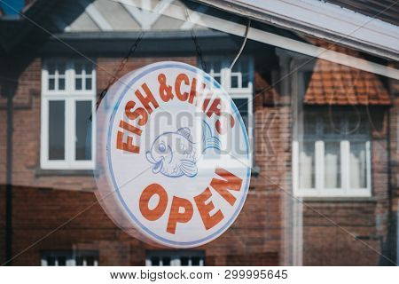 Sheringham, Uk - April 21, 2019: View Though The Window Of An Open Sign In A Fish And Chips Shop In 
