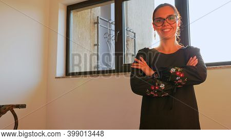 Portrait Of Woman Office Manager Looking To Camera Having Good Mood Standing On Stairs In Corporate 