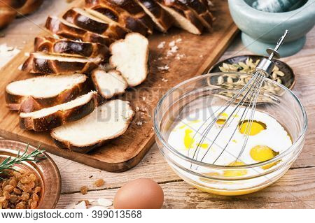 Bread Pudding. Milk And Eggs In A Mixing Bowl. Close-up. Pudding Ingredients On Wooden Table