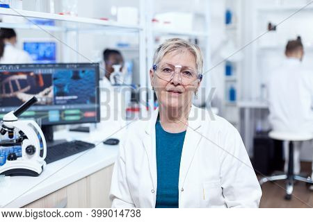 Senior Medical Research In Scientific Clinic With Virus On Computer Display. Elderly Scientist Weari