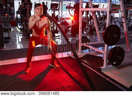 Fitness Man Workout With Battle Ropes At Gym. Training Exercise Fitted Body In Club. Torso, Starts A