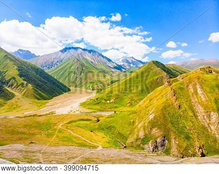 Panoramic Views Of Green Caucasus Mountains And Old Tower Ruins Of Ancient Towers. Georgia And Russi