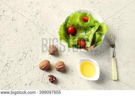 Salad And A Bowl Of Walnut Oil