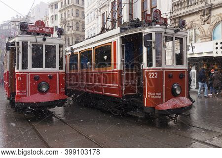 Istanbul, Turkey - January 31, 2012 : Nostalgic Trams Were Passing By Istiklal Street When Snowfalls
