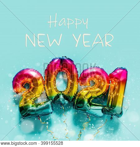 Rainbow Colored Foil Balloons In The Form Of Numbers 2021 On Blue Background