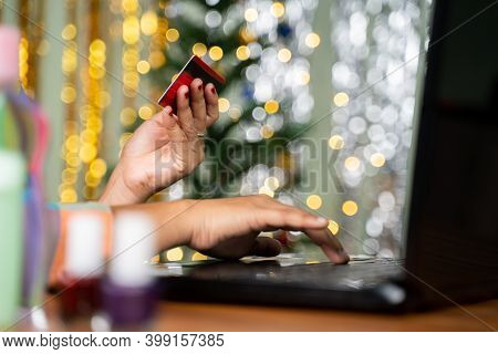 Concept Showing Of Girl Purchasing Cosmetic Products Online By Holding Card In Hand And Busy On Lapt