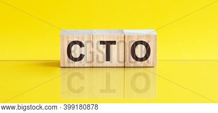 Cto - Chief Technical Officer - Word Is Made Of Wooden Building Blocks Lying On The Yellow Table