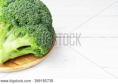 Fresh Green Broccoli On The Plate On White Wooden Table With Copoy Space.