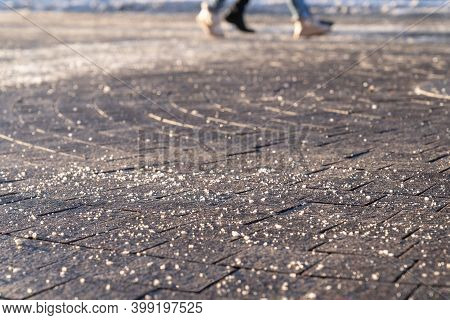 De-icing Chemical Reagent On The Road Will Make The Road Safe In Winter Time. Pavement Is Sprinkled 