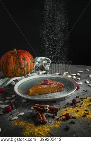 Powdered Sugar Falls On Pumpkin Pie. Side View
