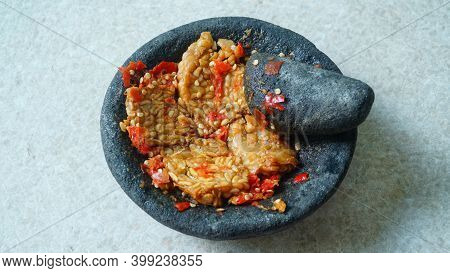 Penyet Tempeh With Chili Sauce In A Stone Mortar