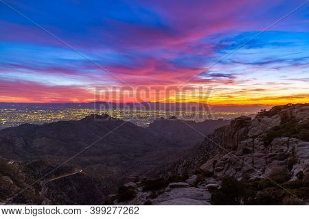 Tucson Arizona As Seen From Above With The Colors Of Sunset In The Distance And Mountains.