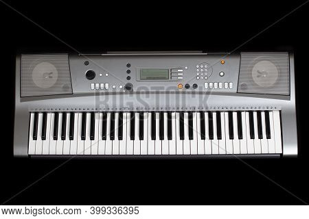 Grey Electronic Synthesizer Without Labels , Isolated On A Black Background