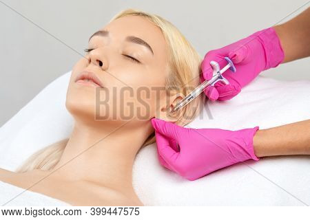 The Doctor Cosmetologist Makes The Injections Procedure For Smoothing Wrinkles And Against Flabbines