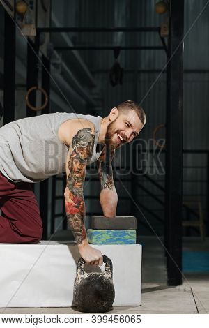 Cheerful Young Disabled Armless Man Training With A Kettlebell
