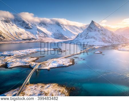 Aerial View Of Bridge Over The Sea And Snowy Mountains In Lofoten Islands, Norway. Fredvang Bridges 