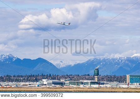 Richmond, Canada - April 05, 2020: Vancouver International Airport Yvr With The Coast Mountains In T