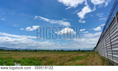 A Wide Famer Agriculture Land Of Rice Plantation Farm After Harvest Season, Under Beautiful White Fl