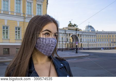 Portrait Beautiful Young Woman In Medical Mask On Palace Square In St. Petersburg. Positive Fashion 