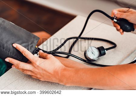 Measurement Of Heart And Blood Pressure Using A Tonometer, Patient And Doctor.
