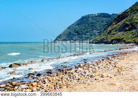 Beautiful Seascape With View On Sea And Mountains On Summer Day, Sea Shore With Pebble Stones And Cu