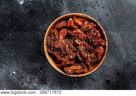 Sun Dried Tomatoes In Wooden Bowl. Black, Dark Background. Top View