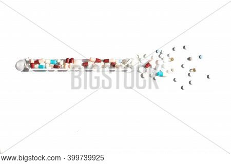 Flat Lay Of Pills On White Background. Piles With Capsule And Test Tube. Pill Bottle Spilling Pills 