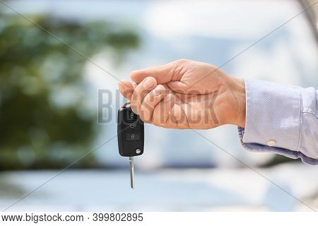 Man With Car Key Outdoors. Automobile A Background