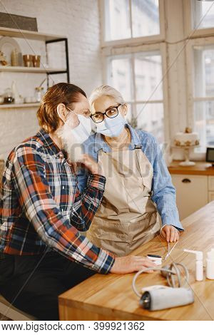 Senior Woman And Man At Home Meassure Blood Pressure