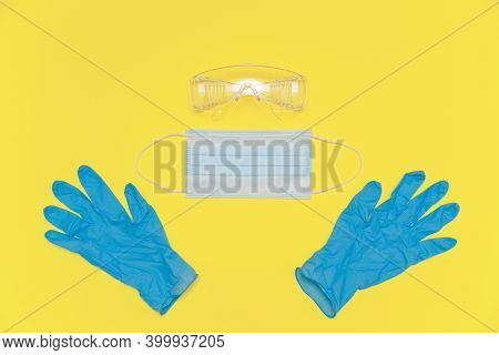 Coronavirus Personal Protective Equipment. Medical Nitrile Gloves, Protective Glasses And Mask On Th