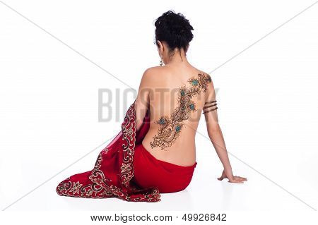 Woman In A Red Sari With Henna Design On Her Back
