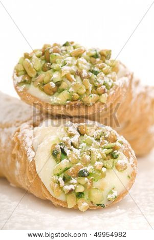Delicious Italian Cannoli with pistachio nuts and powdered sugar