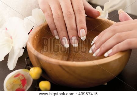 Woman's hands in bowl of water