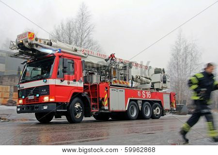Rushed Fireman And Volvo FL12 Fire Engine Arriving At Fire Scene