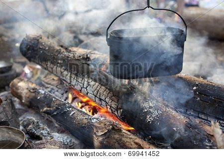 A Dixy On The Fire Is On Stones In The Forest