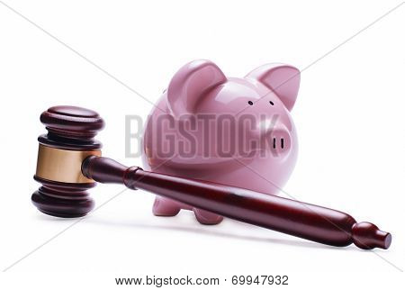 Piggy Bank Next To A Wooden Judge Gavel