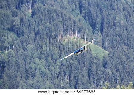 Glider During The Course Of Training Exercise Flying Over The Mountains In Leoben, Austria.