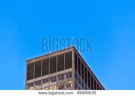 Facade Of  Buildings In The Afternoon With Iron Man Statue O From  Antony Gormley On The Roof