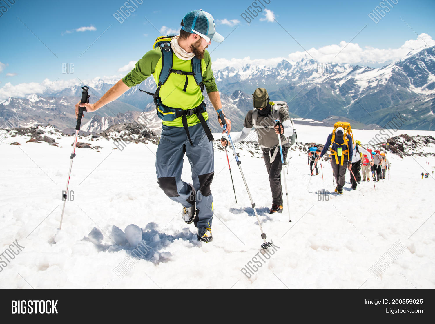 a group of mountaineers rises to the top of a snow-capped
