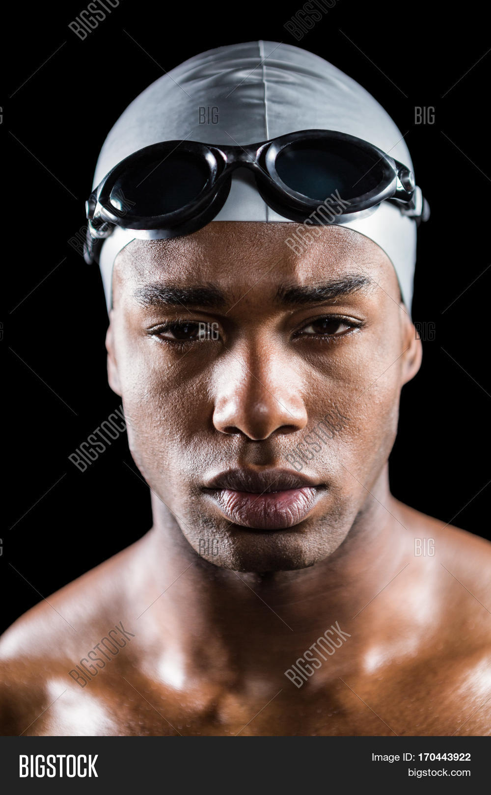 of swimmer in swimming goggles and swimming cap on black back