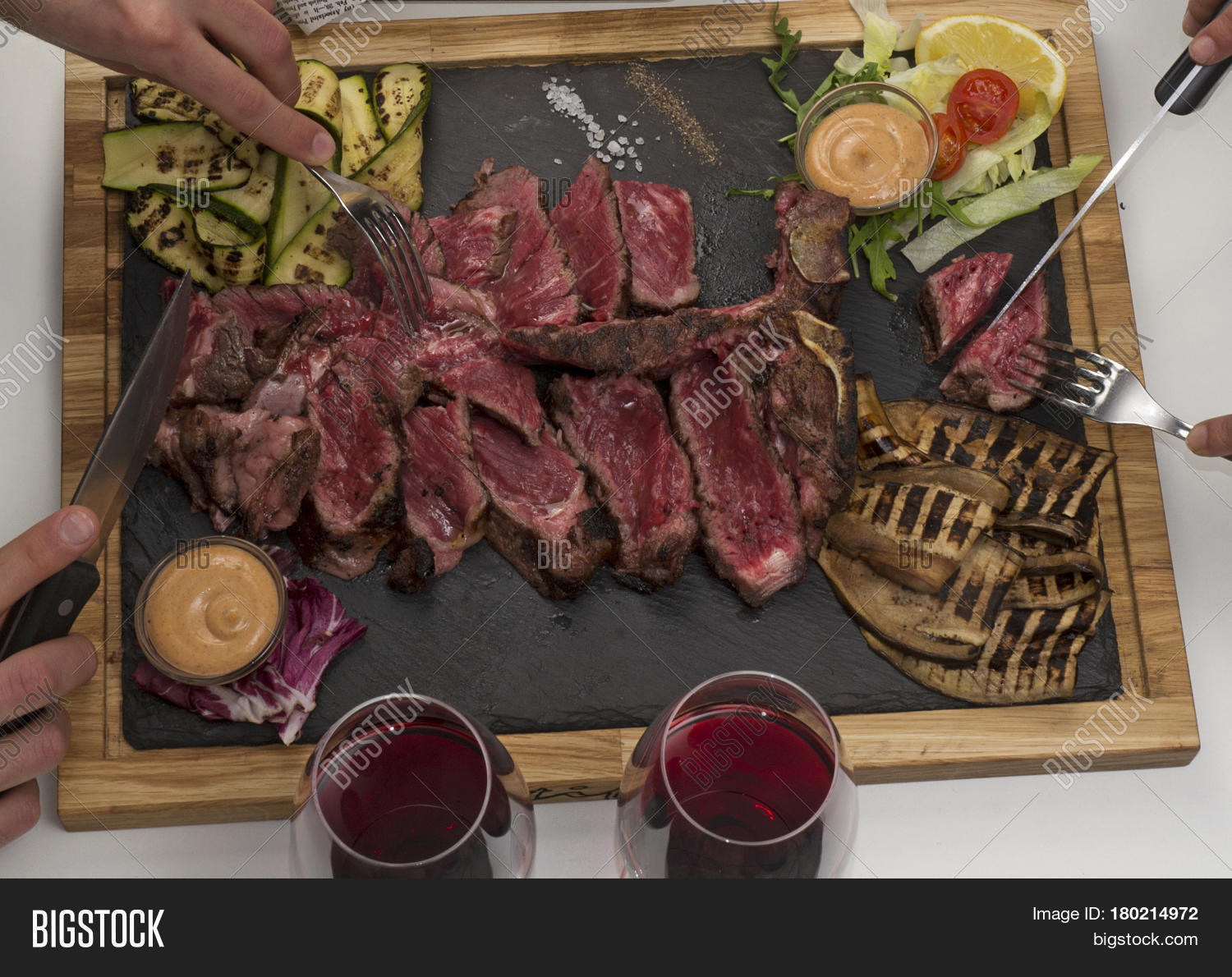 people eating beef steak.